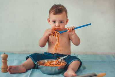 Portrait of cute boy eating food