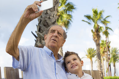 Grandfather taking selfie with grandson