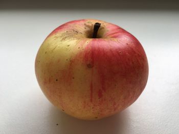 Close-up of red apple on white background