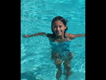 Portrait of young woman in swimming pool