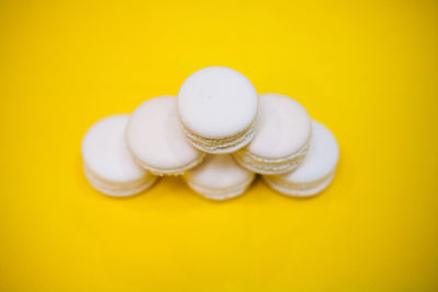 Close-up of white candies against yellow background