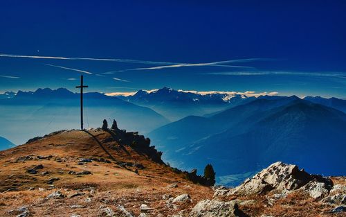 Panoramic view of snowcapped mountains against blue sky
