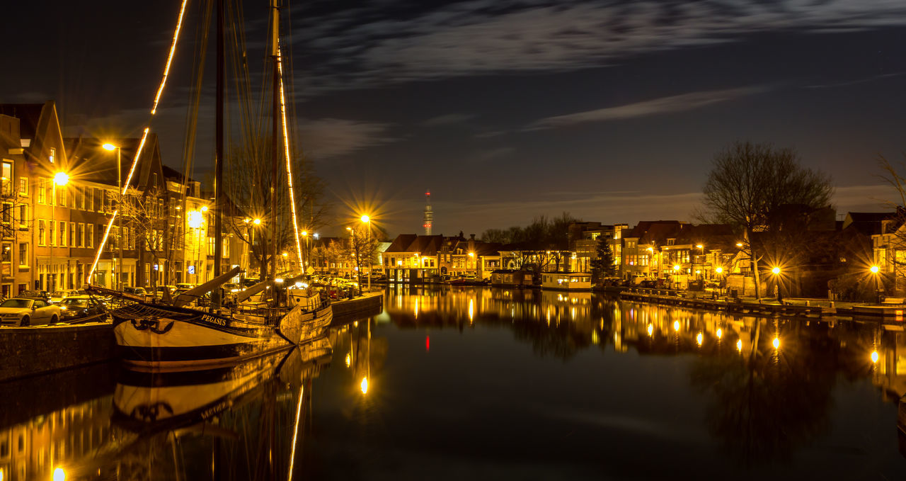 illuminated, water, reflection, waterfront, harbor, nautical vessel, transportation, night, moored, river, built structure, city, architecture, boat, mode of transport, building exterior, sky, mast, commercial dock, marina