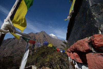 Low angle view of mountain against blue sky