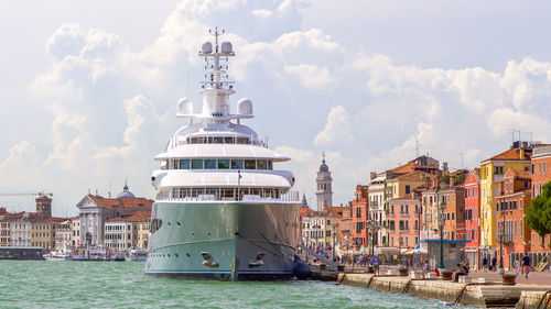 View of residential district in front of sea against sky