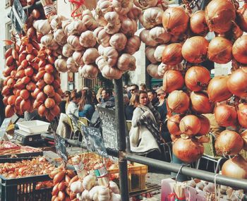 Onions and garlic pods for sale at market stall