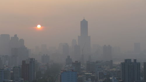 Cityscape against sky during foggy weather