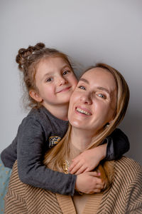 Portrait of young woman against white background