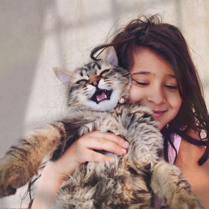 Portrait of woman with cat