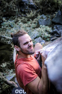 Portrait of young man on rock