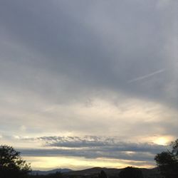 Scenic view of mountains against cloudy sky