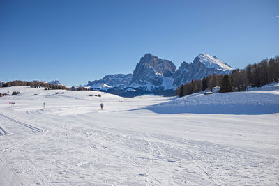 Scenic view of snowcapped mountains against clear blue sky