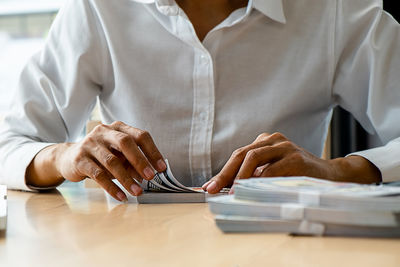 Midsection of man working at table