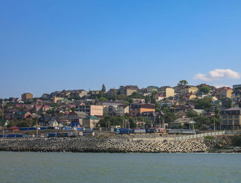 Town by sea against clear sky