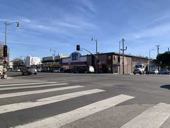 View of city street and buildings against sky