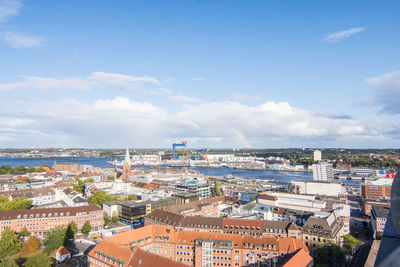 High angle view of townscape by sea against sky