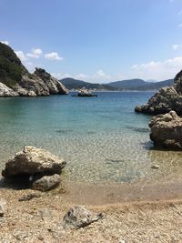 Calm beach against mountains