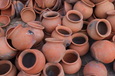 New or damaged pots are gathered and arranged in a pattern in the empty space. 