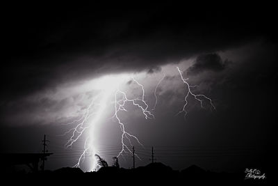 Low angle view of lightning against sky at night