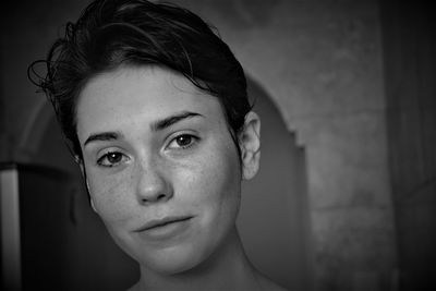 Portrait of smiling young woman with short hair at home