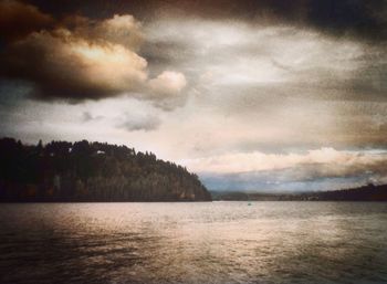 Scenic view of sea against cloudy sky