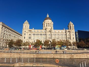 Low angle view of historical building against clear blue sky