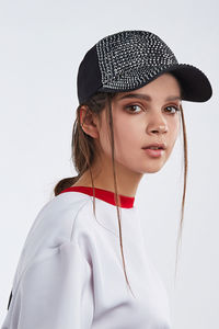 Portrait of beautiful young woman against white background