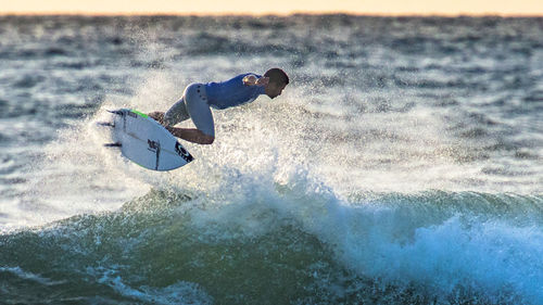 People surfing in sea