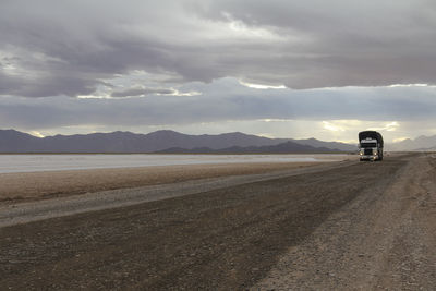 Road by landscape against sky