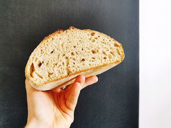 Close-up of hand holding cake