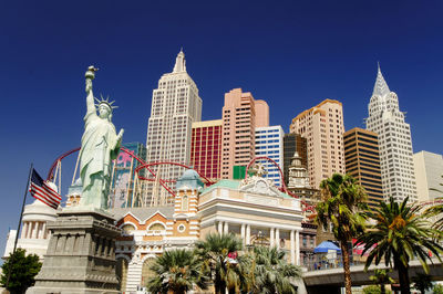 Low angle view of buildings against blue sky