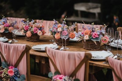 Wedding table decoration and seating with flowers and roses and plate