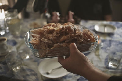 Cropped hand of person holding food