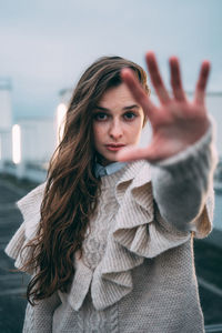 Portrait of woman standing in park during winter