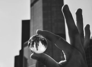 Close-up of hand holding crystal ball