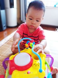 Boy playing with baby at home