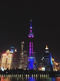 Low angle view of skyscrapers lit up at night