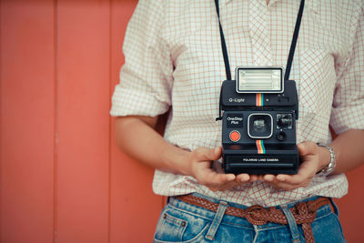 Midsection of woman photographing