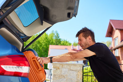Side view of man using mobile phone