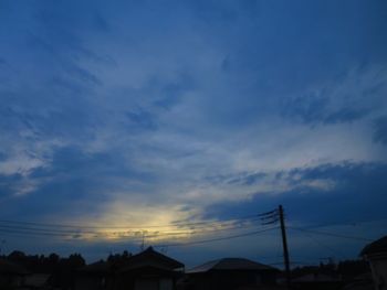 Low angle view of silhouette buildings against sky at sunset