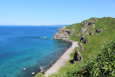 Scenic view of sea against clear blue sky