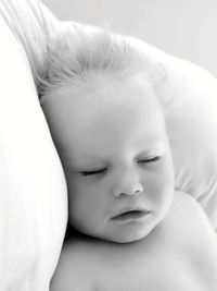 Close-up of cute baby sleeping on bed 