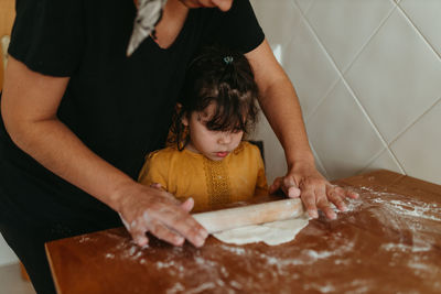 Mother and daughter preparing pizza