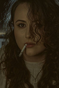 Close-up of young woman smoking cigarette