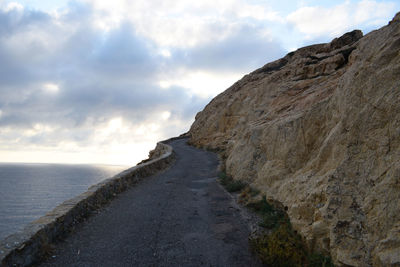 Scenic view of sea and mountains against sky