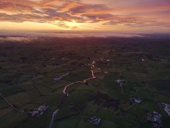 Aerial view of landscape against sky during sunset