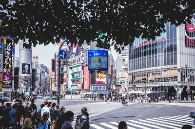 People crossing street in city