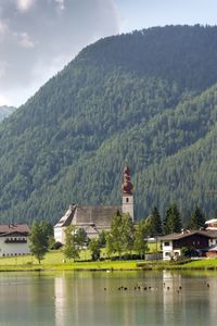 Houses by mountain against sky