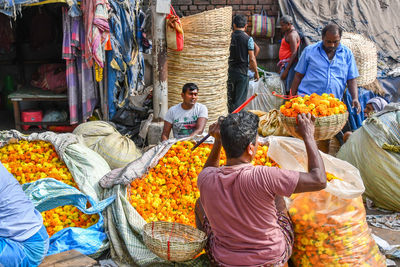 Group of people for sale at market stall