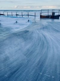 Scenic view of sea against sky during winter